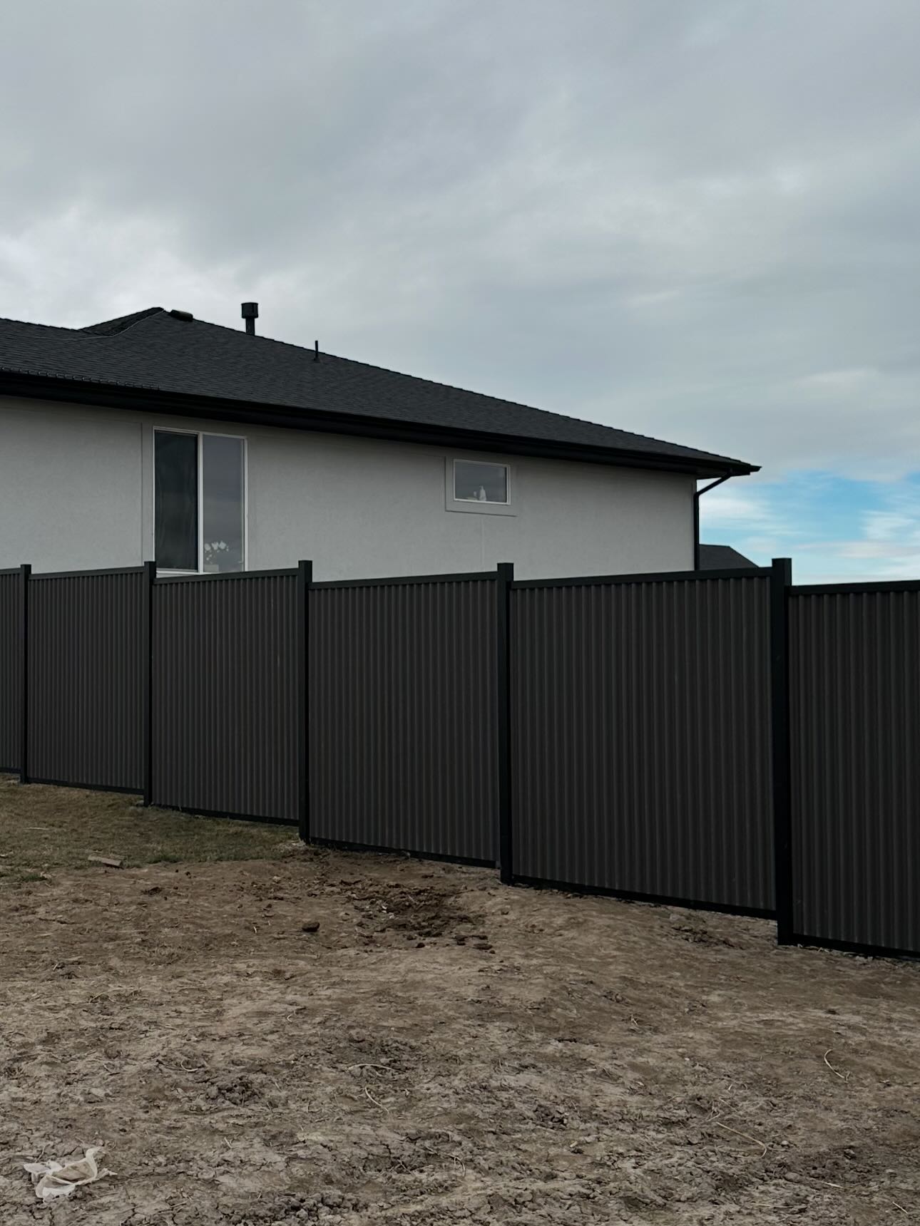 Modern metal panel fence installation